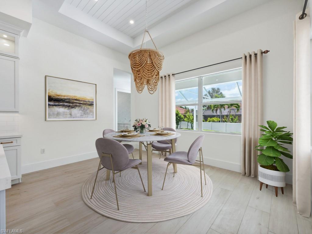 Undisclosed Address Naples, FL 34110 - Photo 9 of 27 a view of a dining room with furniture window and wooden floor