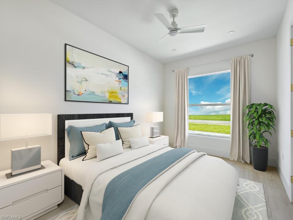 Undisclosed Address Naples, FL 34110 - Photo 10 of 27 a bedroom with a bed and a painting on the wall