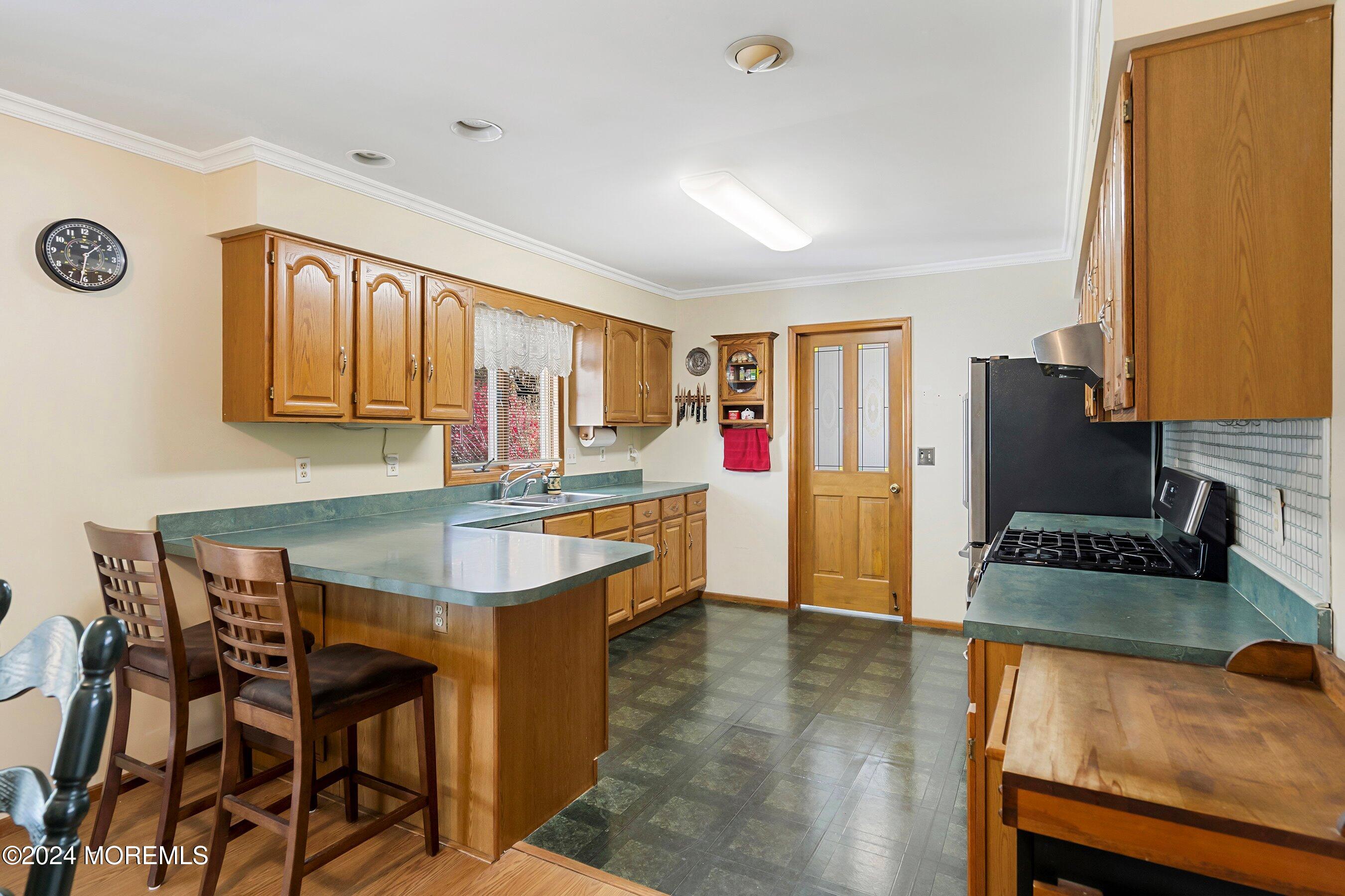 305 Bayside E Parkway Forked River, NJ 08731 - Photo 19 of 39 a living room with kitchen island furniture and a wooden floor