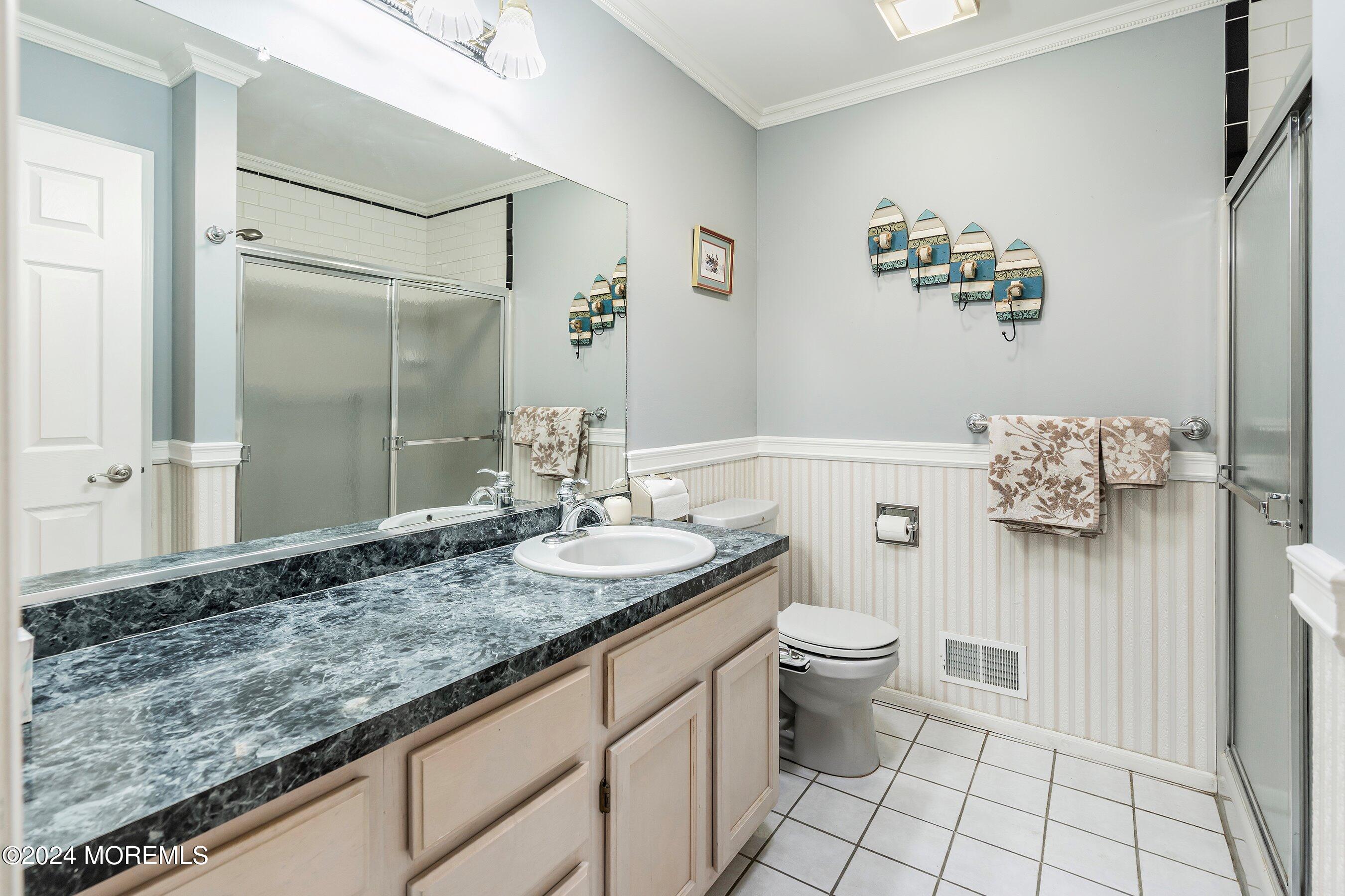 305 Bayside E Parkway Forked River, NJ 08731 - Photo 26 of 39 a bathroom with a granite countertop sink a toilet and a mirror