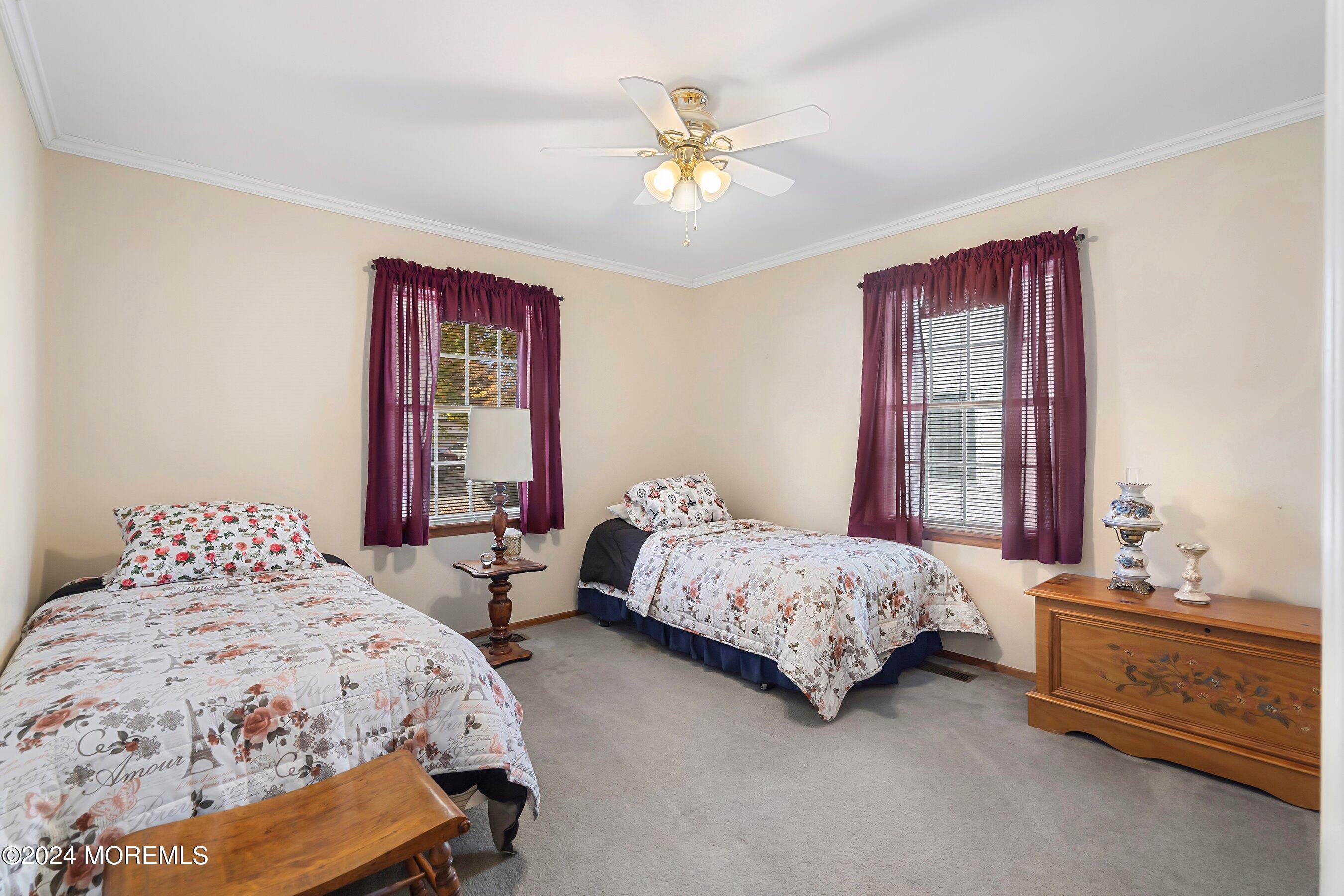 305 Bayside E Parkway Forked River, NJ 08731 - Photo 28 of 39 a bedroom with two beds and a chandelier