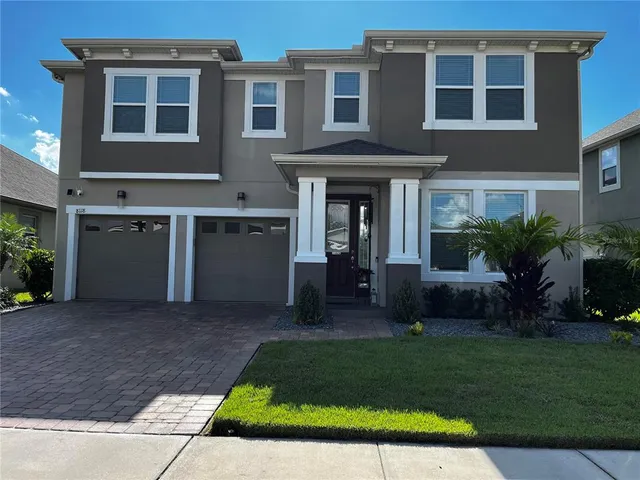 a front view of a house with a yard and outdoor seating