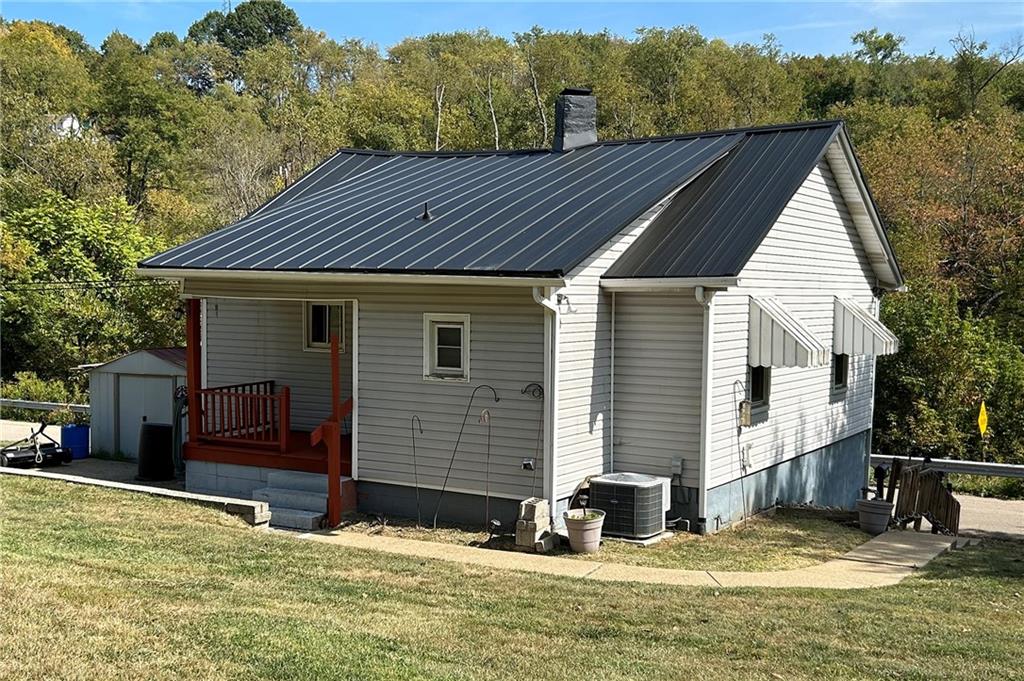 a view of house with swimming pool and sitting area