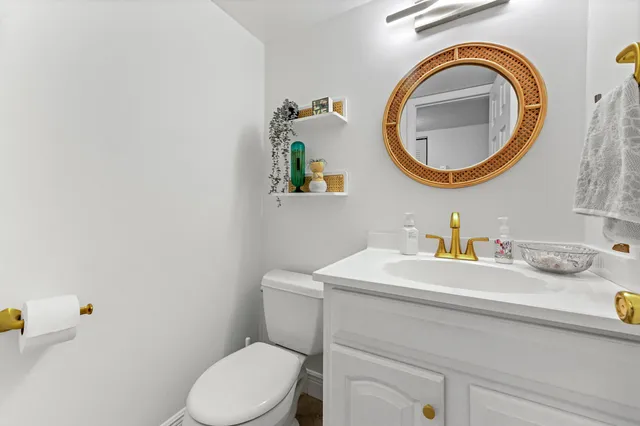 a bathroom with a sink a mirror and a toilet