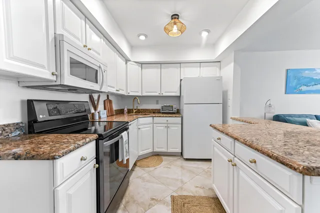 a kitchen with a sink stove and refrigerator