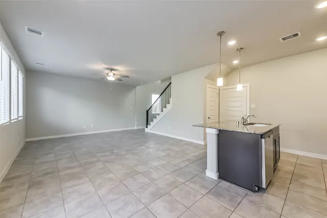 a view of a room with kitchen and windows
