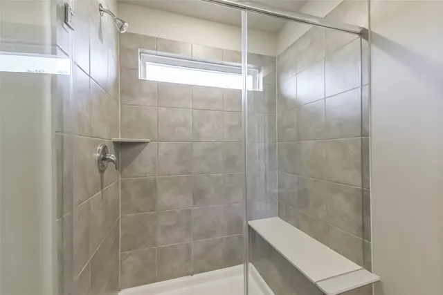 a bathroom with a shower and a toilet