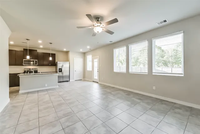 a view of kitchen with cabinets and window