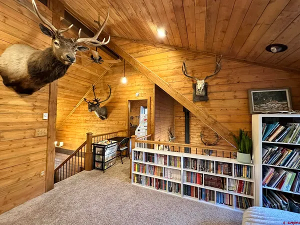 a view of an empty room and wooden shelves