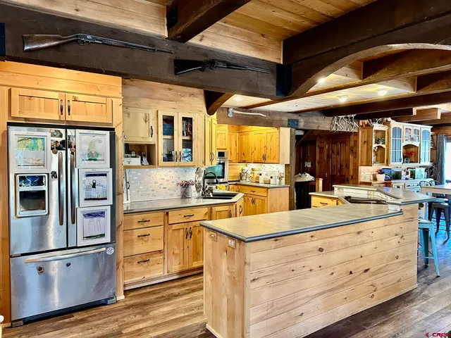 a view of a kitchen with furniture and chandelier