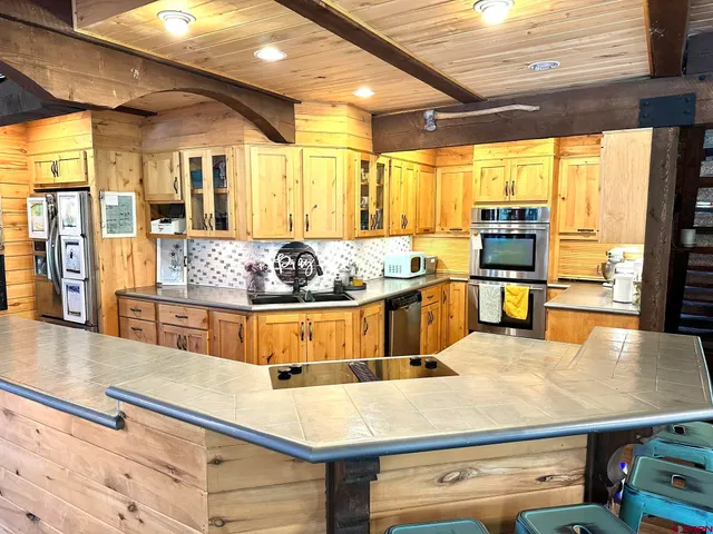 a view of a dining room with furniture a chandelier and wooden floor
