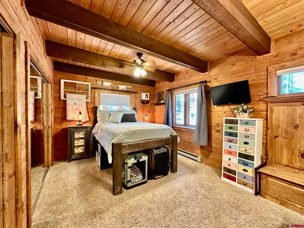 a bed sitting in a bedroom next to a balcony