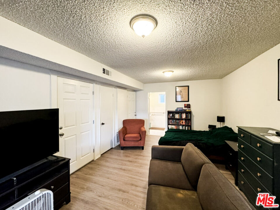 12511 Culver Boulevard Los Angeles, CA 90066 - Photo 12 of 26 a living room with furniture and a flat screen tv