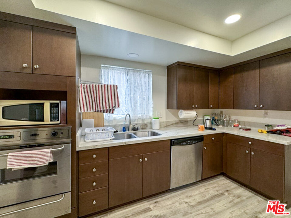 12511 Culver Boulevard Los Angeles, CA 90066 - Photo 13 of 26 a kitchen with a sink a stove and cabinets