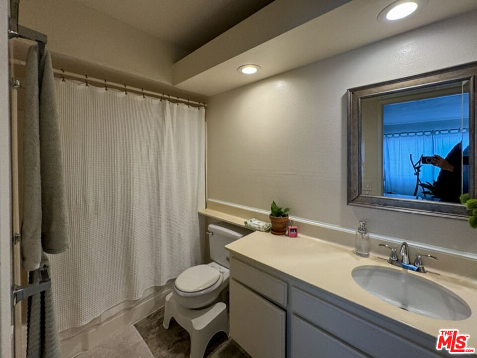12511 Culver Boulevard Los Angeles, CA 90066 - Photo 19 of 26 a bathroom with a granite countertop sink and a mirror
