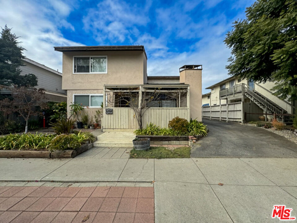 12511 Culver Boulevard Los Angeles, CA 90066 - Photo 2 of 26 a front view of a house with garden