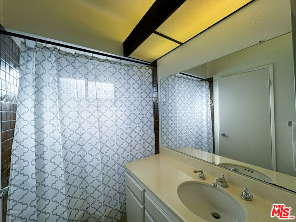 12511 Culver Boulevard Los Angeles, CA 90066 - Photo 3 of 26 a bathroom with a sink and a shower