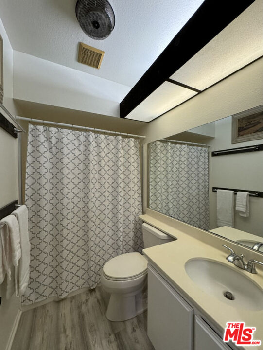 12511 Culver Boulevard Los Angeles, CA 90066 - Photo 7 of 26 a bathroom with a sink a toilet and shower curtain