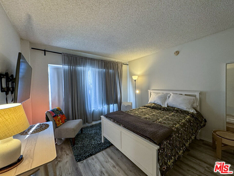 12511 Culver Boulevard Los Angeles, CA 90066 - Photo 8 of 26 a bedroom with a bed and a couch