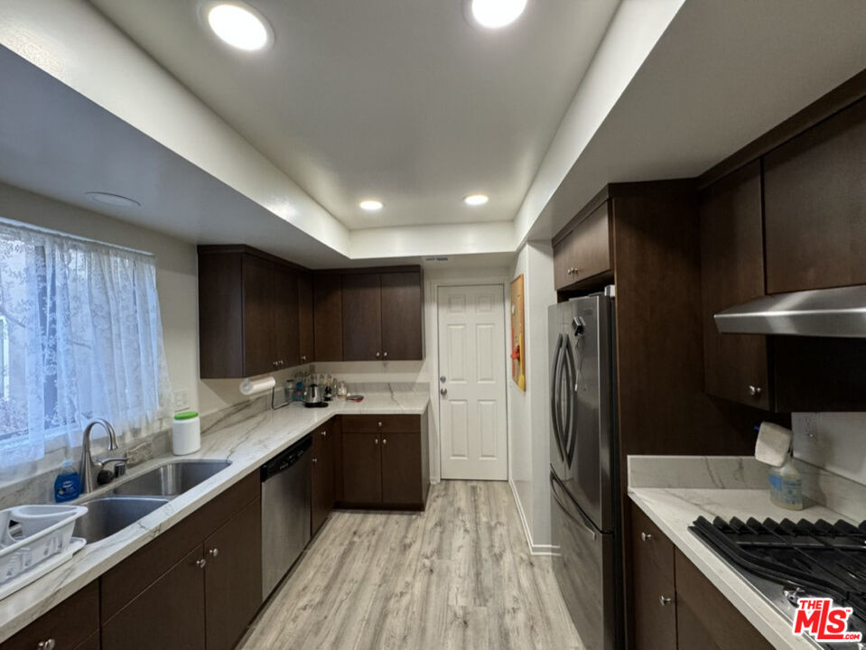 12511 Culver Boulevard Los Angeles, CA 90066 - Photo 10 of 26 a kitchen with stainless steel appliances granite countertop a sink stove and refrigerator