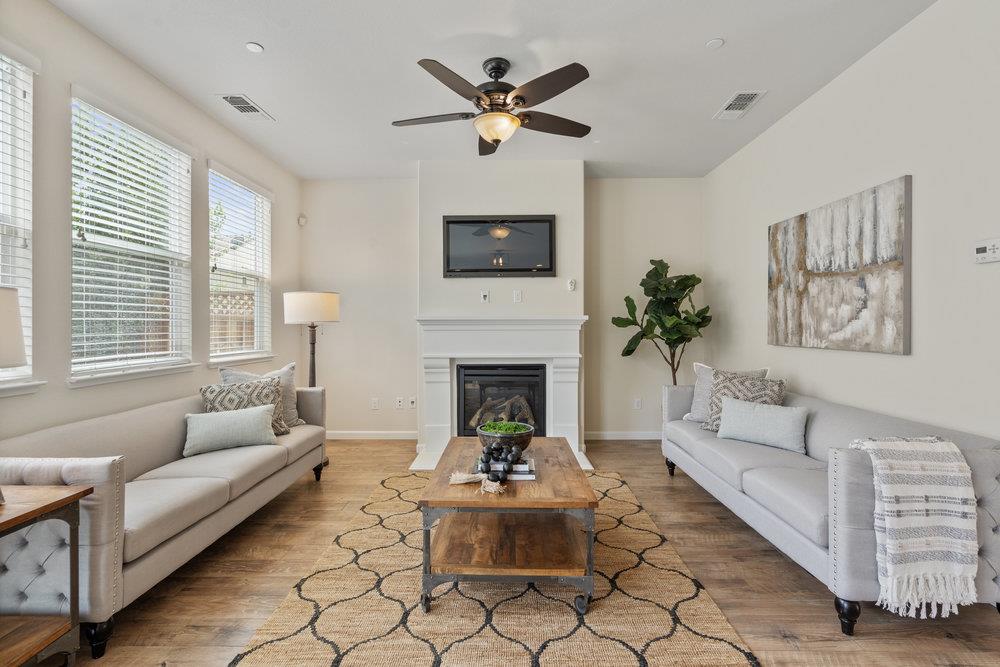 130 Lusitano Way Gilroy, CA 95020 - Photo 12 of 50 a living room with furniture a fireplace and a large window