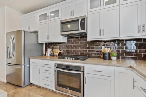 a kitchen with a refrigerator and a sink