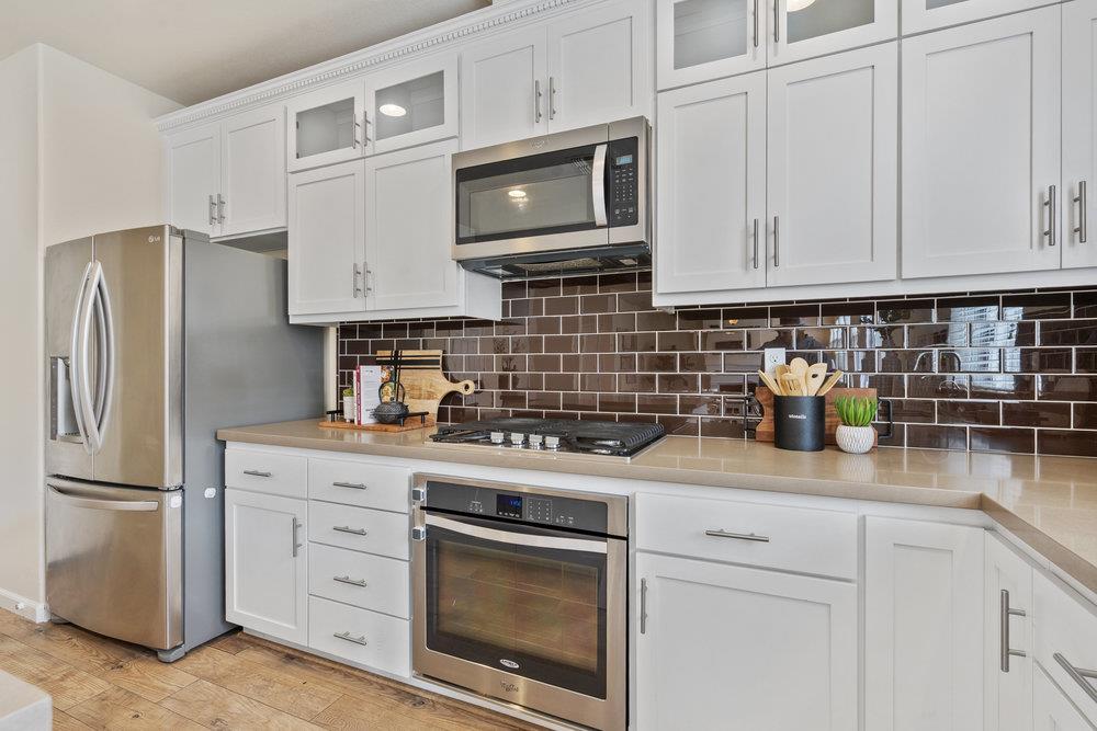 130 Lusitano Way Gilroy, CA 95020 - Photo 17 of 50 a kitchen with stainless steel appliances granite countertop white cabinets a refrigerator a stove a sink and dishwasher