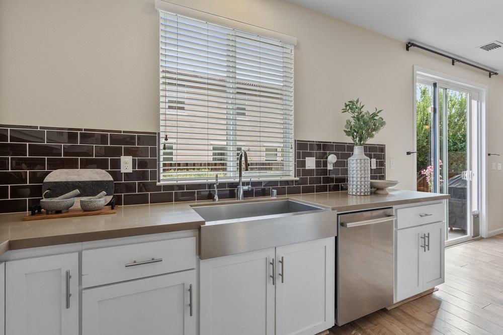 130 Lusitano Way Gilroy, CA 95020 - Photo 19 of 50 a kitchen with stainless steel appliances white cabinets a potted plant and a sink