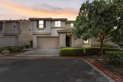 a front view of a house with a yard and a garage