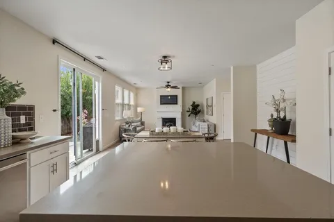 a view of a bedroom with a bed and a mirror