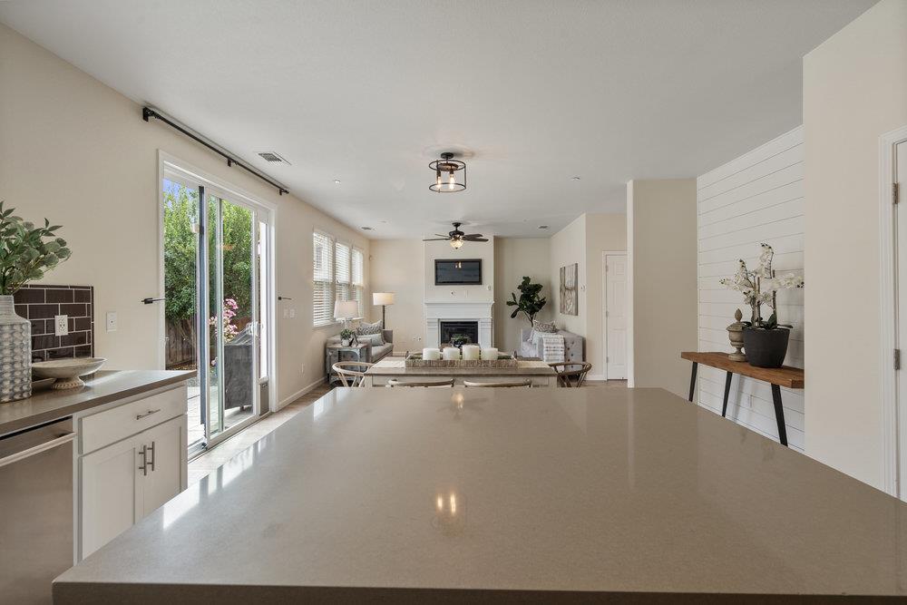 130 Lusitano Way Gilroy, CA 95020 - Photo 21 of 50 a view of a kitchen with kitchen island a counter top space a sink a stove and a refrigerator with wooden floor