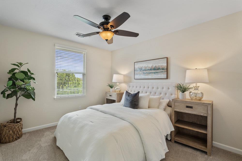 130 Lusitano Way Gilroy, CA 95020 - Photo 23 of 50 a bedroom with a bed and a potted plant
