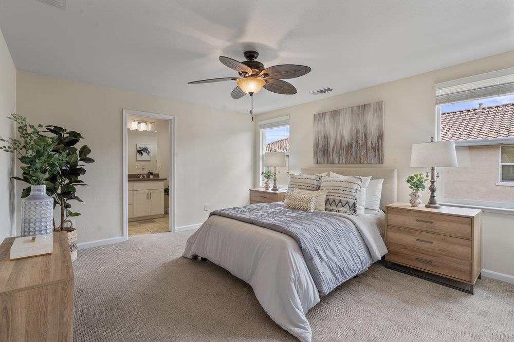 130 Lusitano Way Gilroy, CA 95020 - Photo 24 of 50 a bedroom with a bed and a potted plant