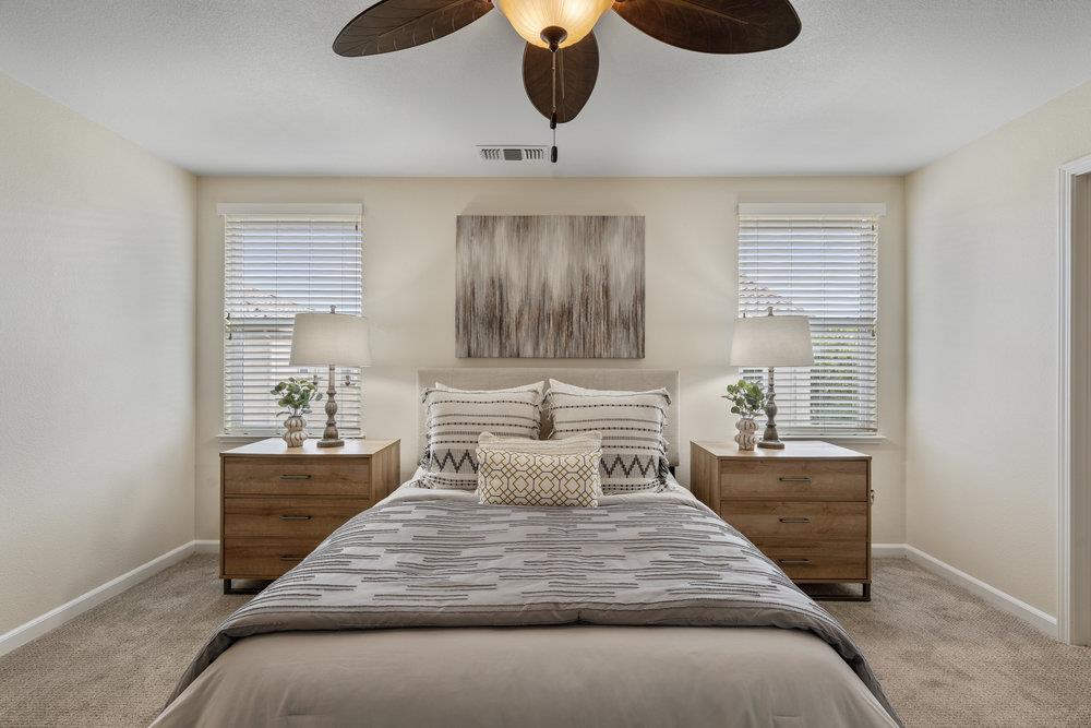 130 Lusitano Way Gilroy, CA 95020 - Photo 25 of 50 a bedroom with a bed a window and potted plant