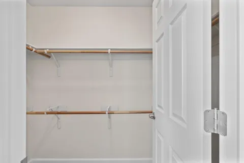 a bathroom with double sink a mirror and a shower