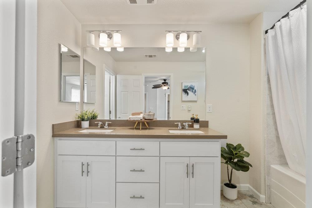 130 Lusitano Way Gilroy, CA 95020 - Photo 27 of 50 a bathroom with double sink a mirror and a shower