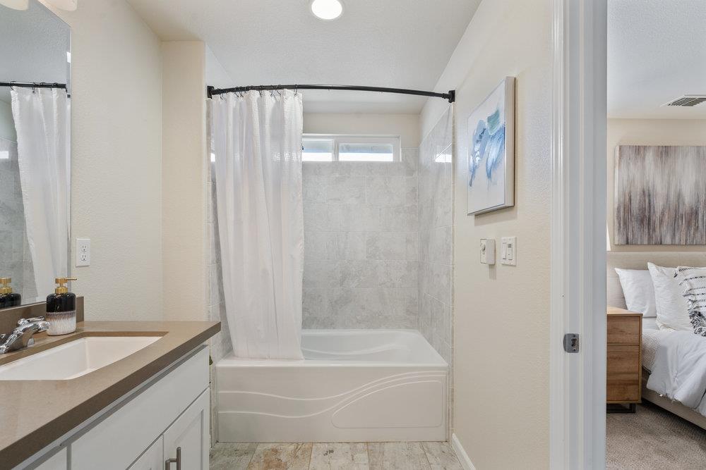 130 Lusitano Way Gilroy, CA 95020 - Photo 28 of 50 a bathroom with a granite countertop sink and a mirror