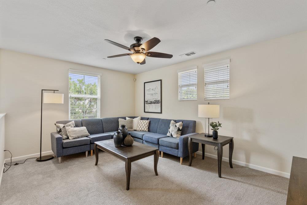130 Lusitano Way Gilroy, CA 95020 - Photo 30 of 50 a living room with furniture a ceiling fan a window and a window