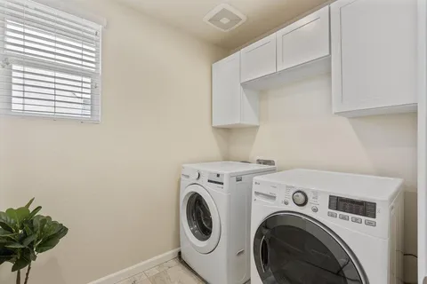 a bathroom with a toilet a sink and a large mirror