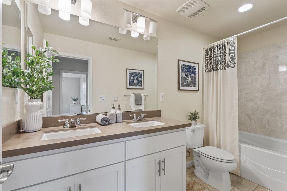 130 Lusitano Way Gilroy, CA 95020 - Photo 36 of 50 a bathroom with a toilet a sink and a large mirror