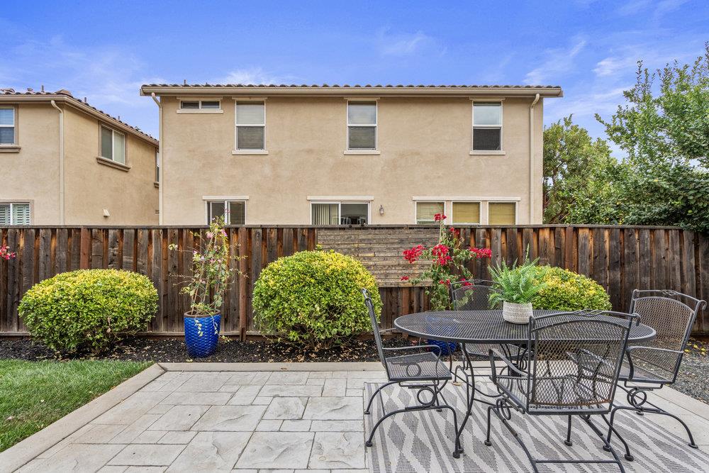 130 Lusitano Way Gilroy, CA 95020 - Photo 37 of 50 a view of a patio with table and chairs and potted plants