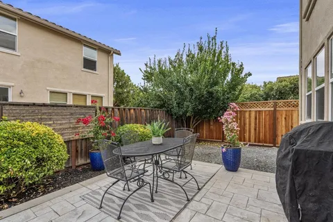 a view of a patio with a chairs and table in a patio