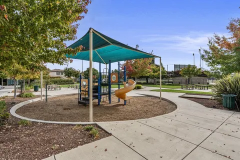 a view of a swimming pool with lawn chairs and a yard