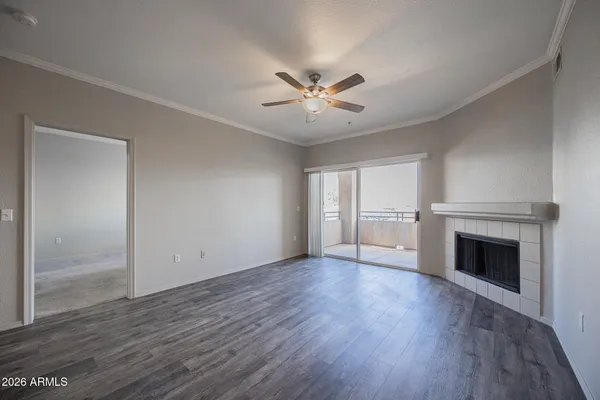 wooden floor fireplace and windows in an empty room