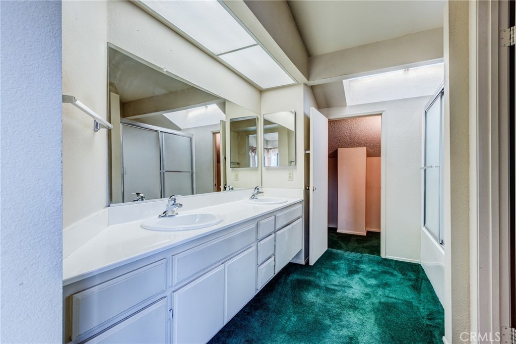 1922 Alta Street Redlands, CA 92374 - Photo 22 of 45 a spacious bathroom with a double vanity sink and a mirror