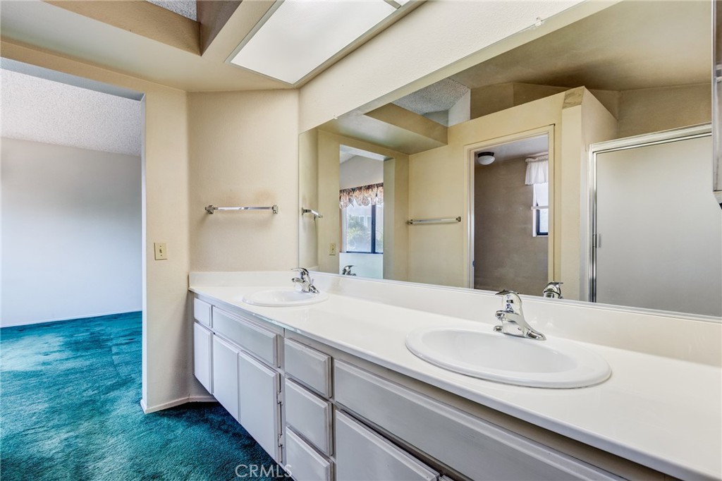 1922 Alta Street Redlands, CA 92374 - Photo 24 of 45 a bathroom with a double vanity sink and mirror