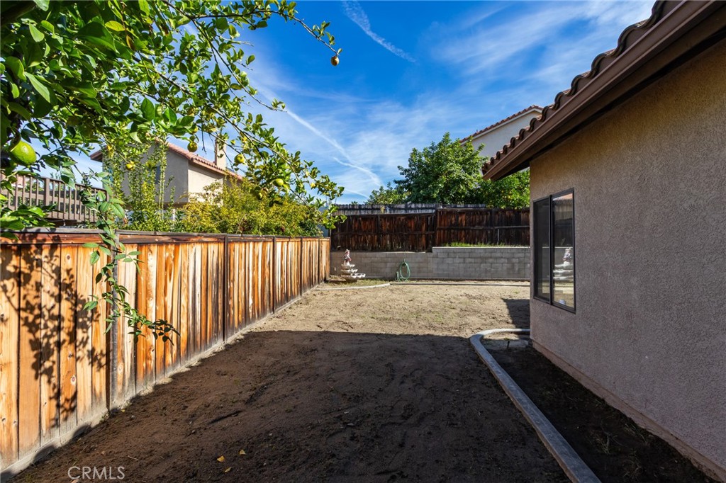 1922 Alta Street Redlands, CA 92374 - Photo 39 of 45 a view of backyard with wooden fence and trees