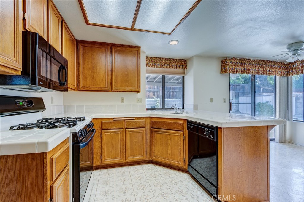 1922 Alta Street Redlands, CA 92374 - Photo 4 of 45 a kitchen with stainless steel appliances granite countertop a sink stove and cabinets