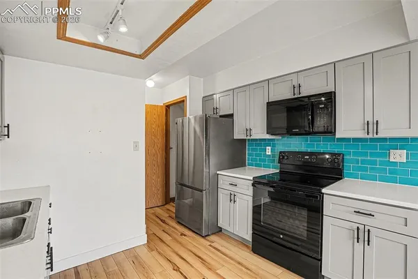 a kitchen with a refrigerator stove and microwave