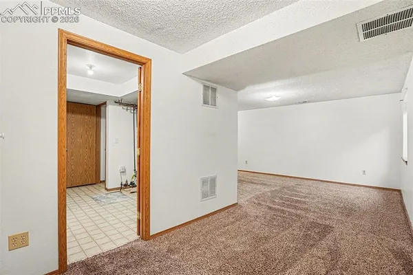 a view of washer and dryer with bathroom in the background